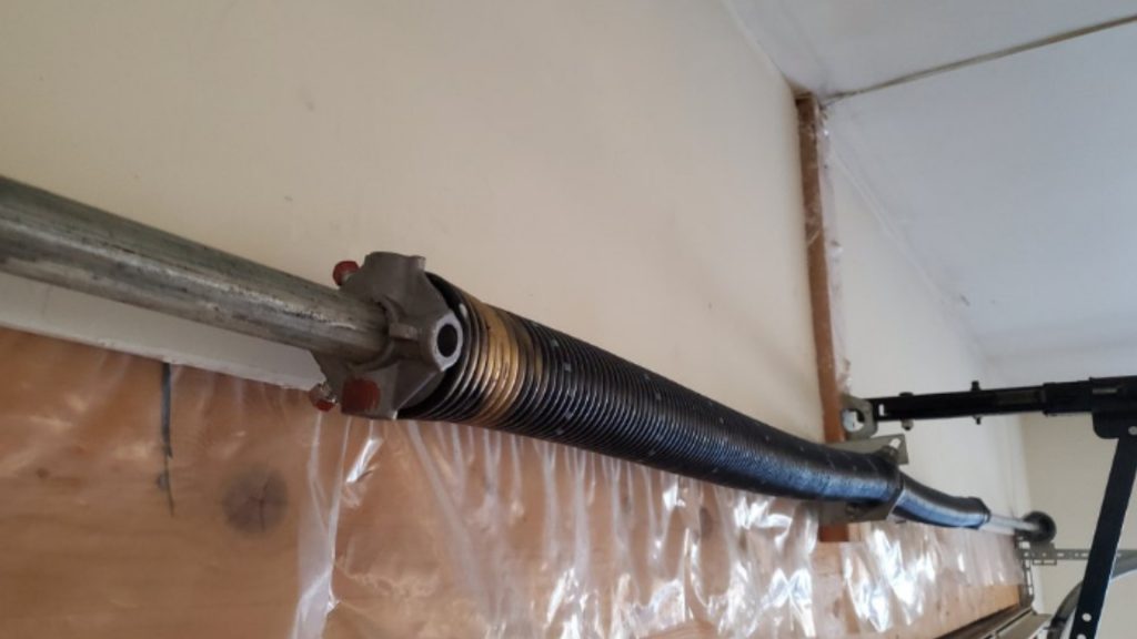 A garage door with a two-spring system