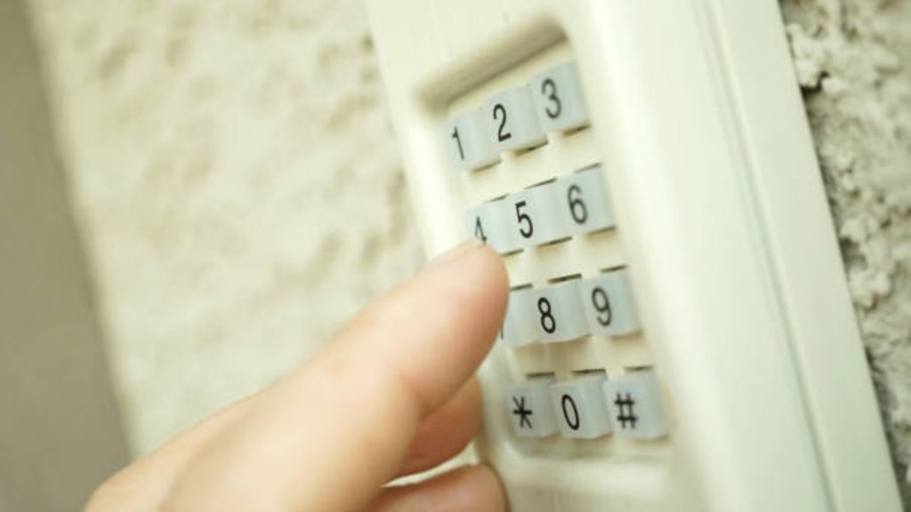 A user putting a code into a garage door keypad