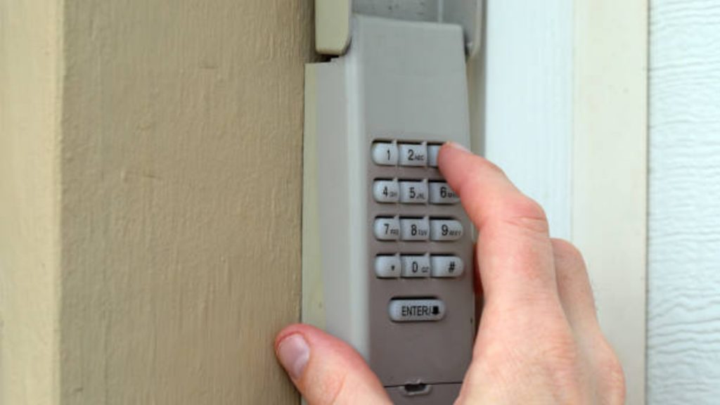 A user putting a code into a garage door keypad