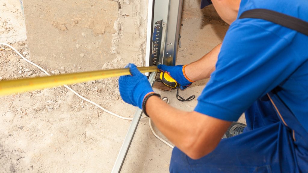 A garage door repair company technician performing a repair