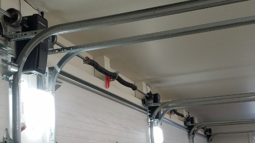 Residential garage doors installed with jackshaft garage door openers