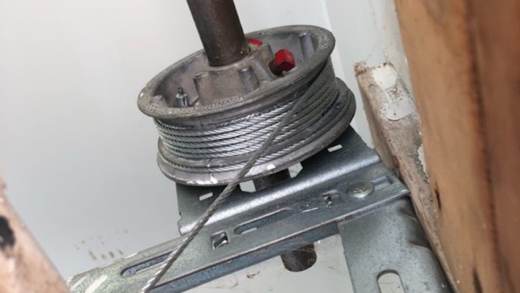 Garage door cable wound on its drum