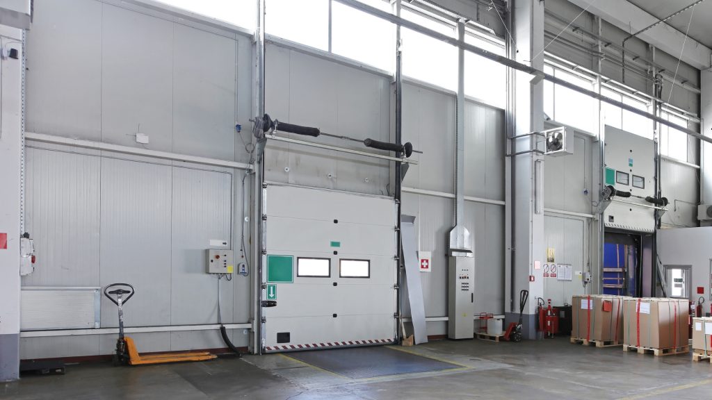 A commercial garage door with full vertical lift.