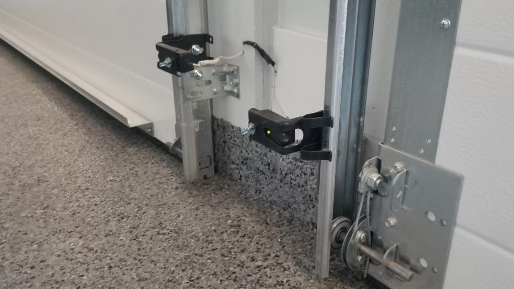 Garage door safety sensors installed at the bottom of the doors