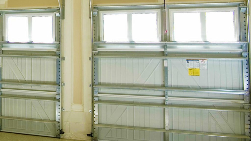 Garage doors with garage door storm braces