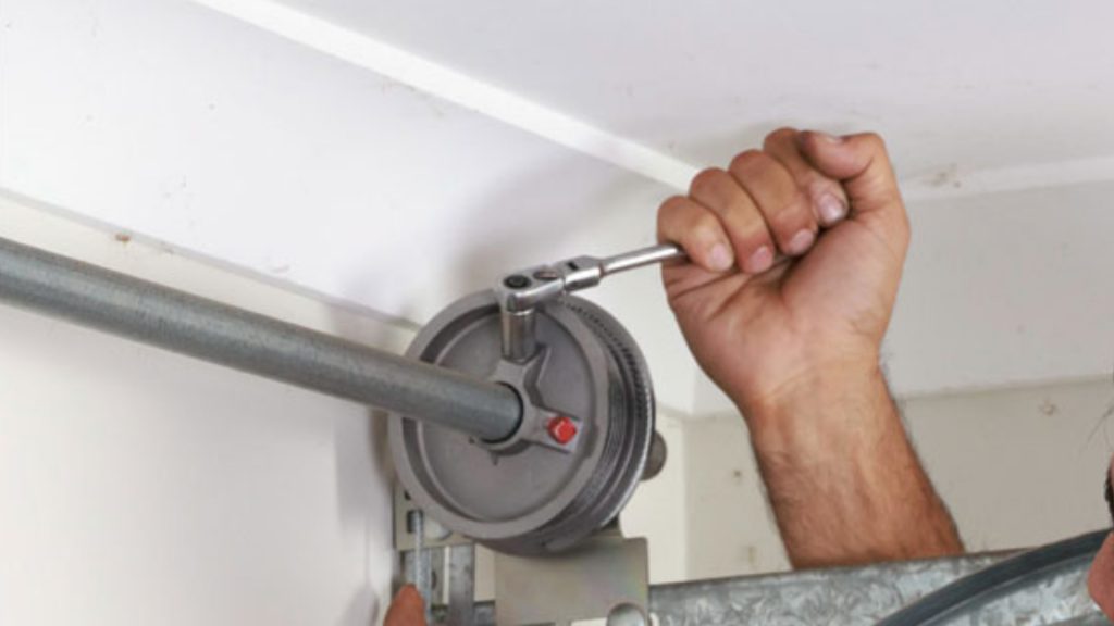A technician performing garage door cable replacement