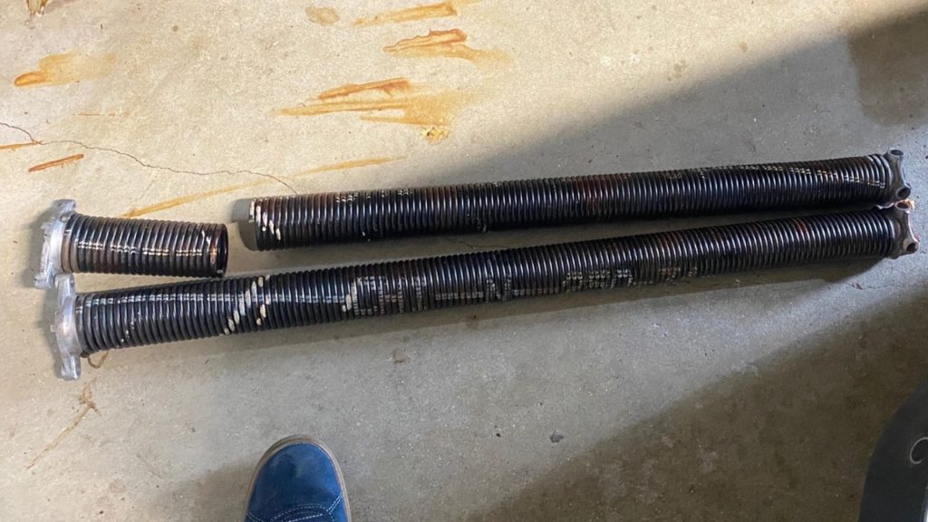 Broken garage door spring that caused the door to get stuck closed