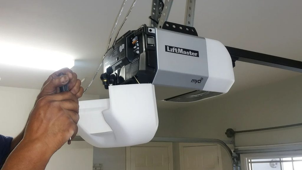 A technician installing a LiftMaster garage door opener