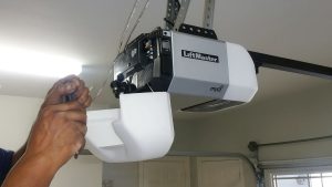 A technician installing a LiftMaster garage door opener