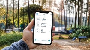 Person using a smart home app outdoors to check garage and lighting status