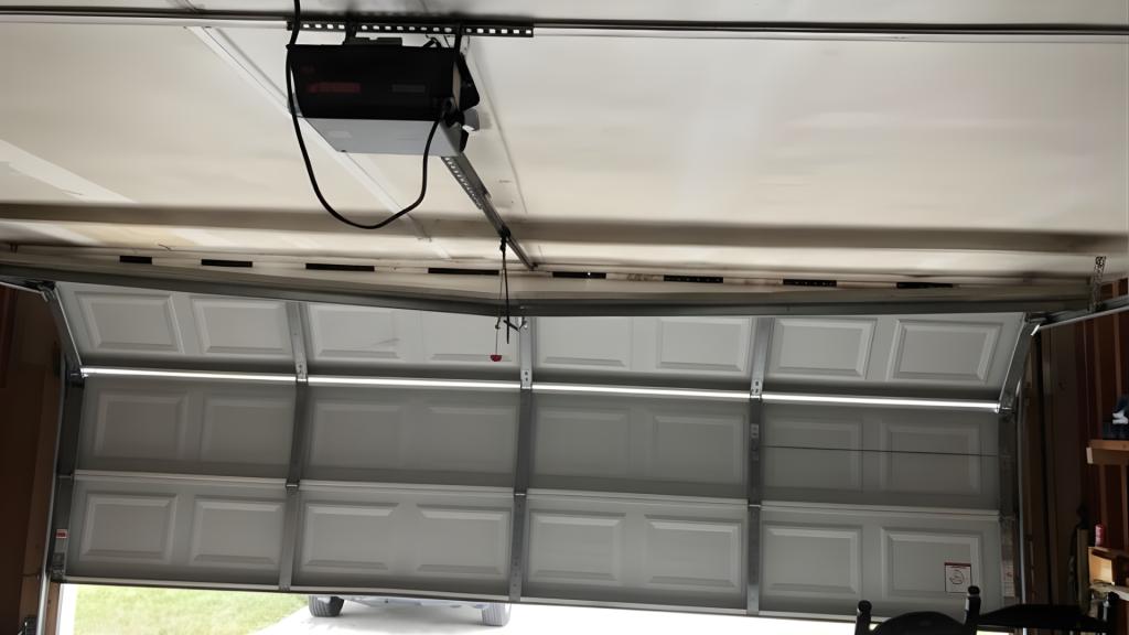 Inside view of a garage door with warped and bent panels.