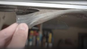 A broken garage door bottom seal in Omaha
